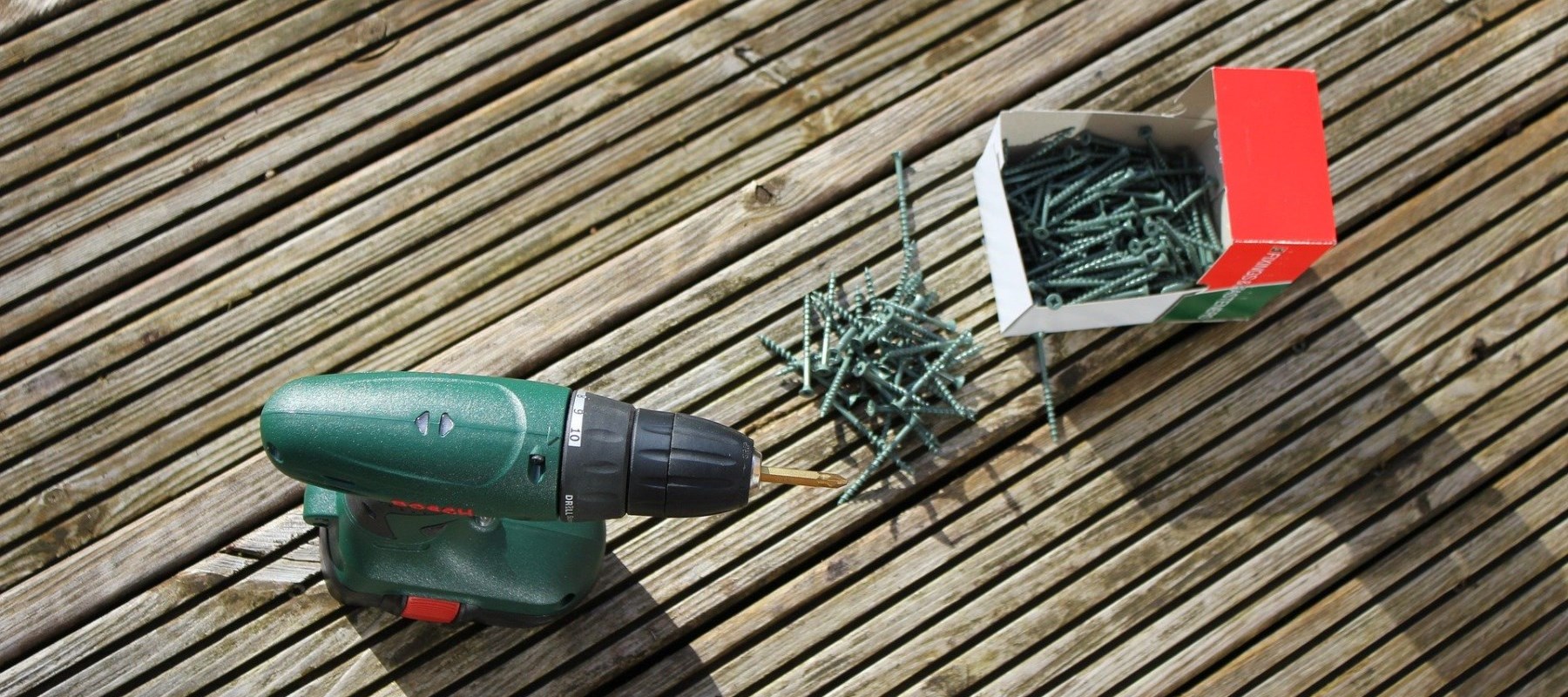 Drill and screws on wooden deck Drill and screws on wooden deck
